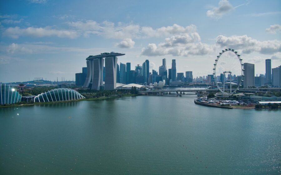 stripe singapore expansion - white boat on water near city buildings during daytime