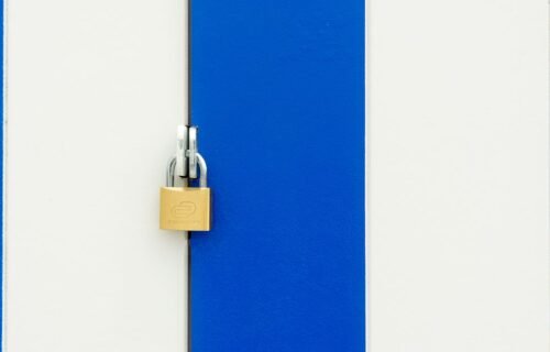 stripe acquires openrouter - Padlock securing a blue and white striped door, symbolizing safety.