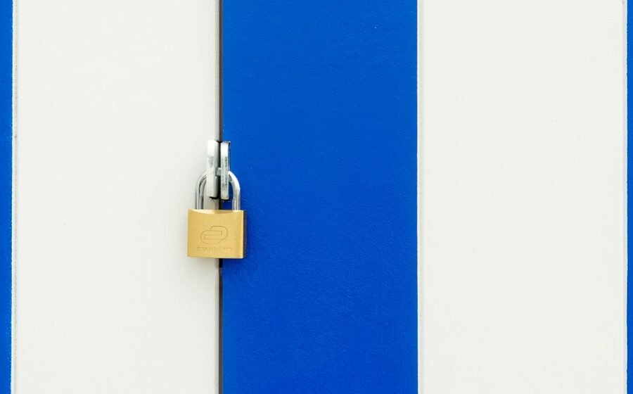 stripe acquires openrouter - Padlock securing a blue and white striped door, symbolizing safety.