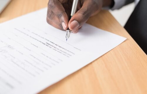 person writing on white paper