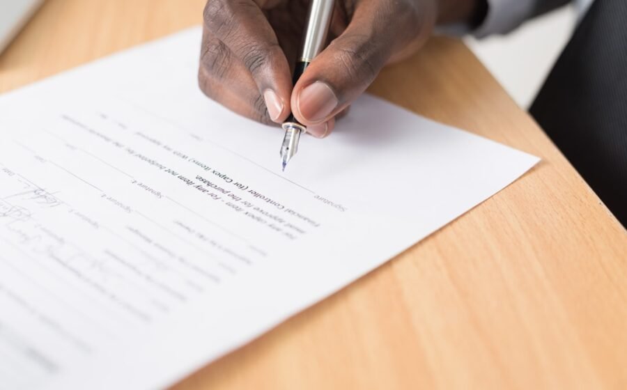 person writing on white paper