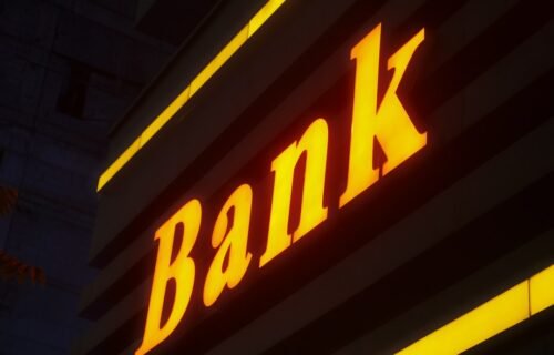 banking as a service BaaS - a bank sign lit up in the dark