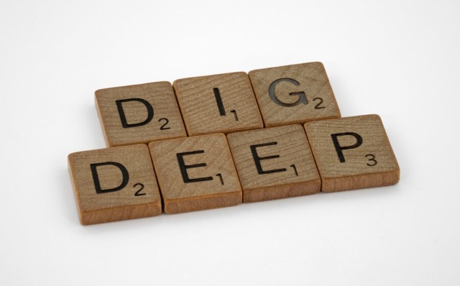 DeFi decentralised finance - a set of scrabble tiles spelling the word dig deep