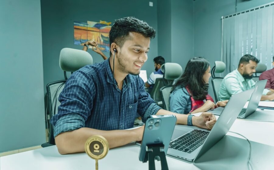 revenue based financing - a man sitting in front of a laptop computer