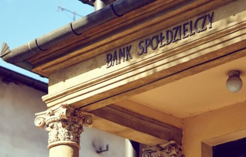 nayax zaria bank charters - Detailed view of a historic Polish bank facade with classic architectural columns.