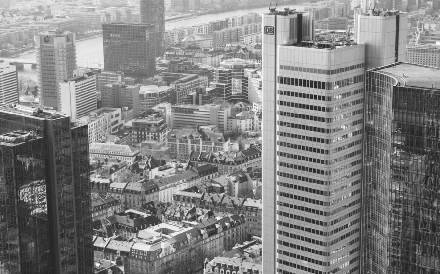 terrapay deutsche bank - A stunning aerial view of Frankfurt am Main's modern high-rise skyline in black and white.