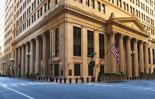 bitcoin nonfarm payrolls - a large building with columns and a flag on the corner