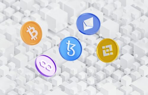 swift blockchain ledger - a group of colorful bitcoins sitting on top of a white background