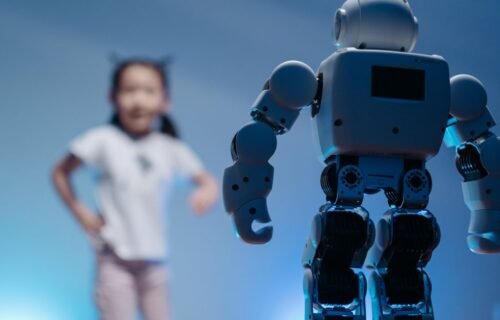 bytedance ai loan - A young girl playfully interacts with a humanoid robot in a futuristic indoor environment featuring soft