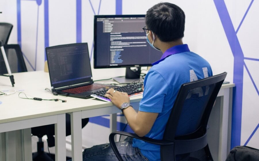 enterprise ai learning - boy in blue t-shirt sitting on black office rolling chair in front of computer