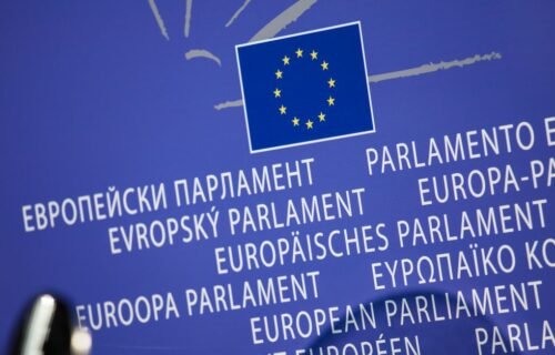 eu dlt cap - Close-up view of the European Union flag with multilingual text showing European Parliament.
