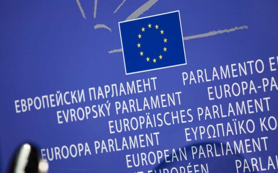 eu dlt cap - Close-up view of the European Union flag with multilingual text showing European Parliament.