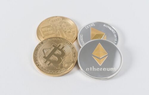 stablecoins cross-border sales - four round silver-colored and gold-colored Bitcoins