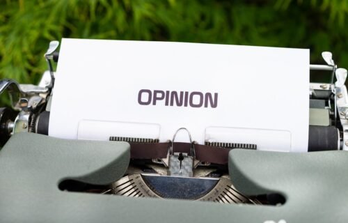 white and black typewriter on green grass during daytime