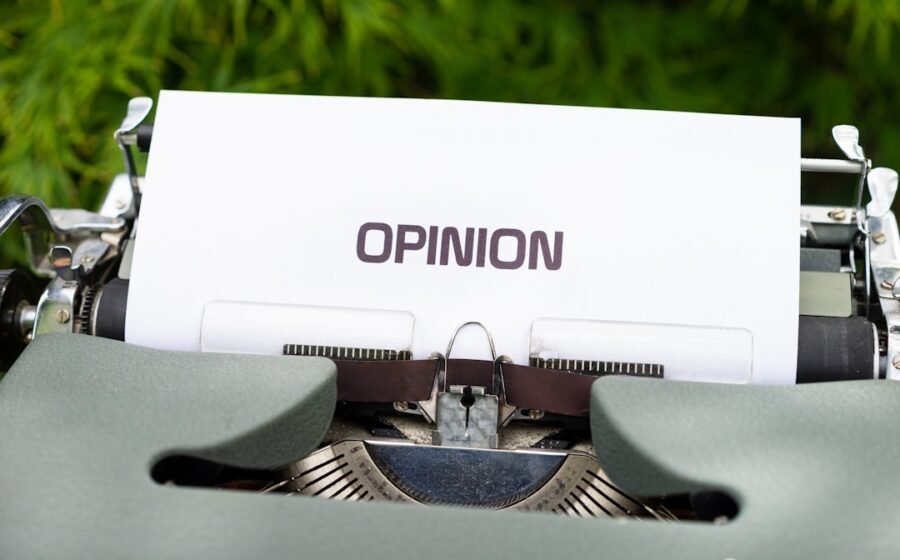 white and black typewriter on green grass during daytime