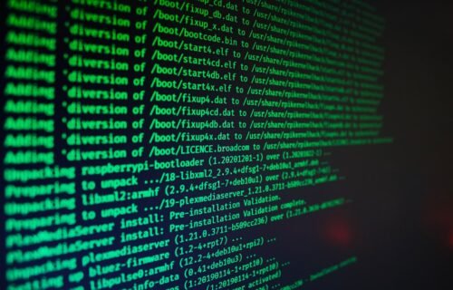 ransomware attack jack henry - Green computer code text scrolling on a dark screen during a software installation