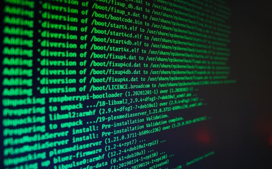 ransomware attack jack henry - Green computer code text scrolling on a dark screen during a software installation