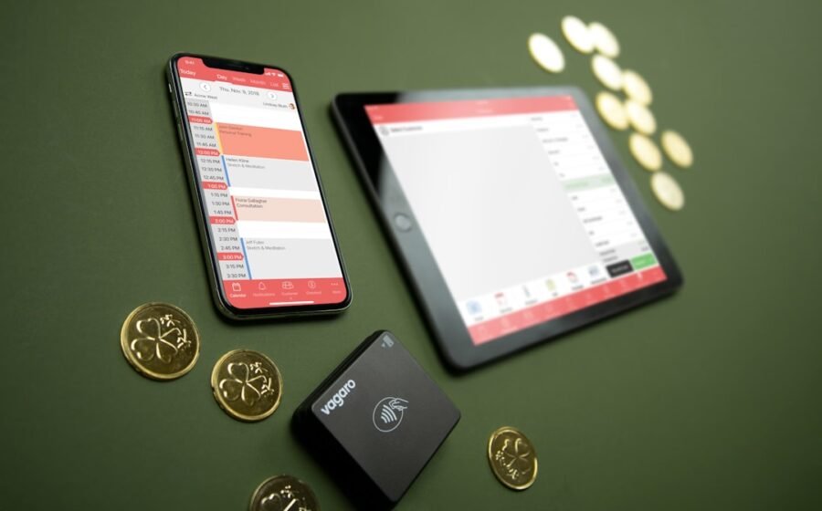 payment acceptance - Smartphone, tablet, payment terminal, and coins on table