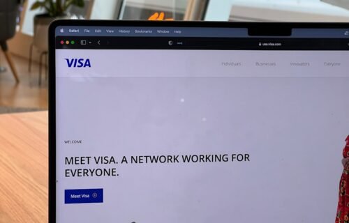 visa stablecoin programs - a computer screen with a window and a person in the background