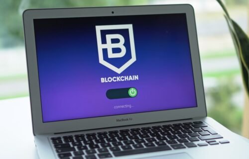 visa onchain credit - A laptop screen displays a blockchain interface, highlighting digital finance technology.