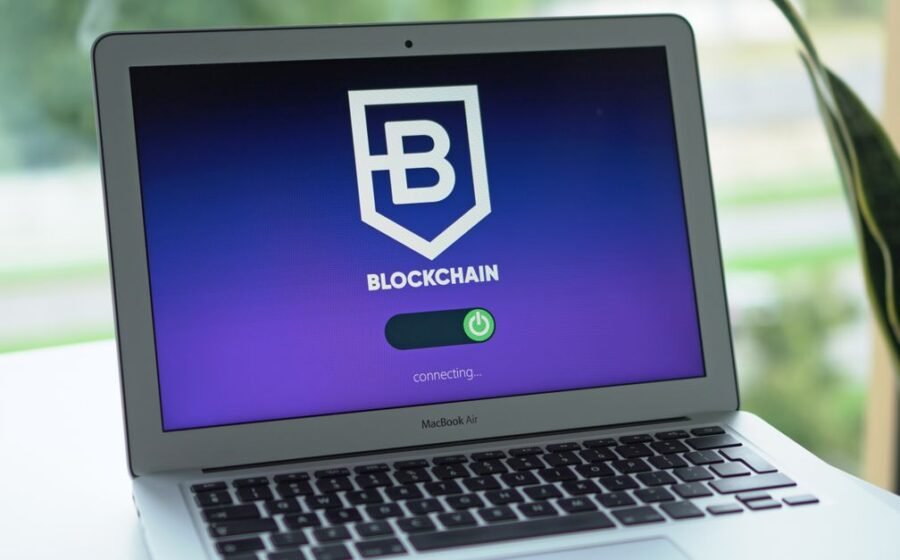 visa onchain credit - A laptop screen displays a blockchain interface, highlighting digital finance technology.